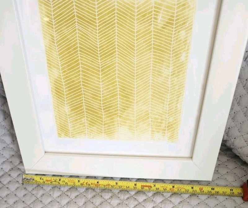 Yellow and White Geometric Print Wall Art Housed in a White Hard Plastic Frame gallery