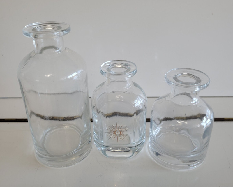 3 CLEAR THICK GLASS DECORATIVE BOTTLES 4 4.25 AND 6 INCHES TALL 1 WITH STARBURST gallery