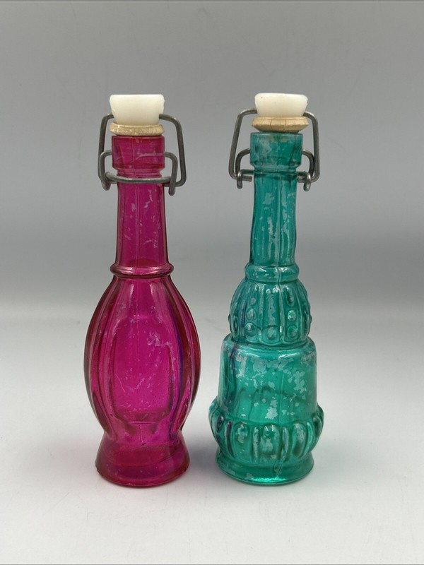 Set Of 2 Colored Glass Bottles With Ceramic Stoppers. 5 ” Tall. Pink And Blue
