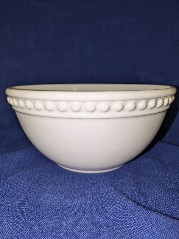 Heavy white ceramic serving mixing bowl.